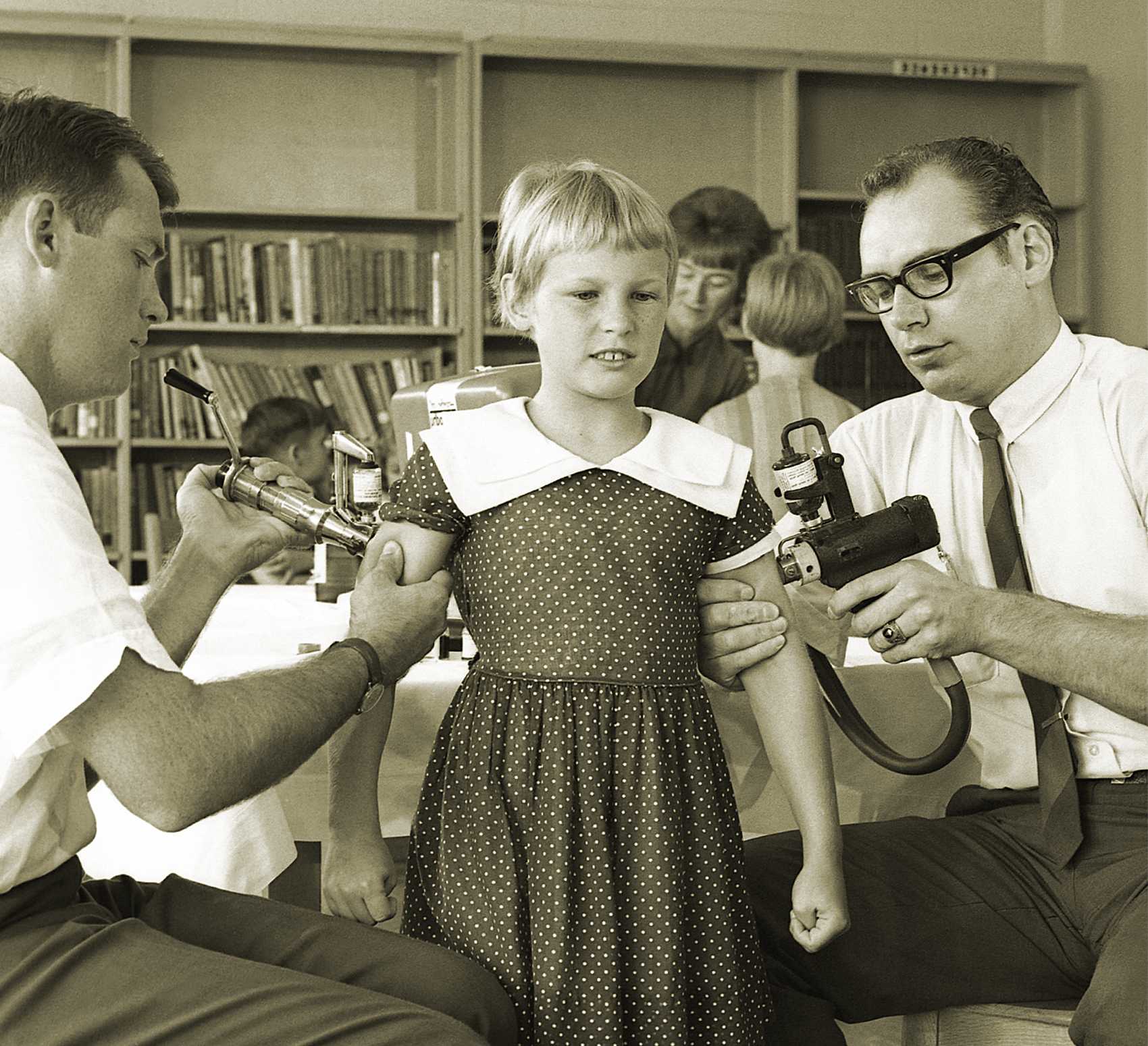 Historical photo of young girl receiving measles vaccine